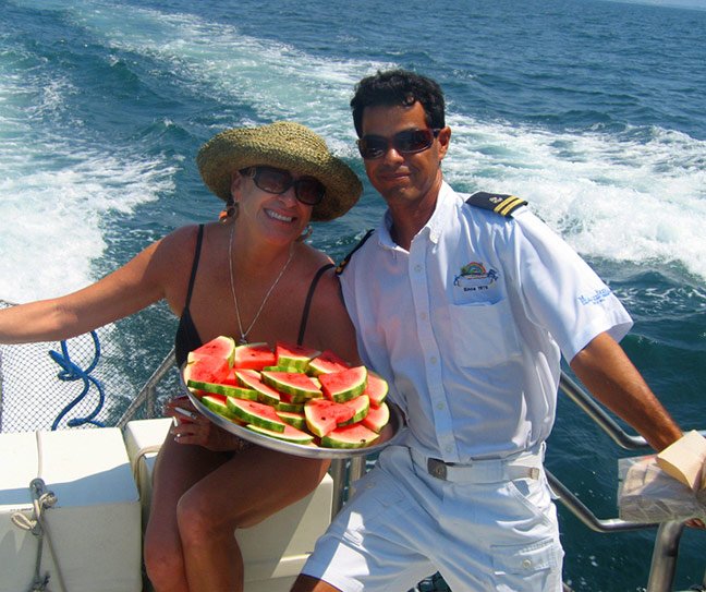 passenger and Tortuga island catamaran crew member