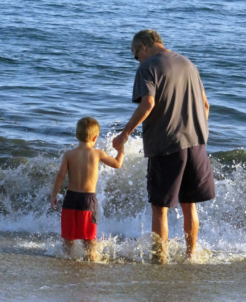 grandfather with grandchild on Costa Rican beach