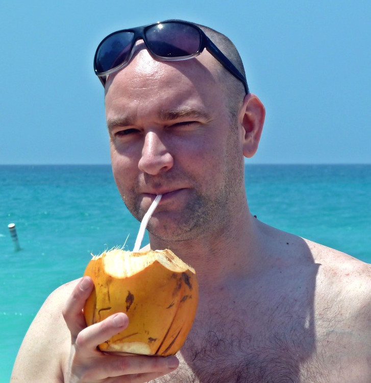 man with a coco loco drink in costa rica